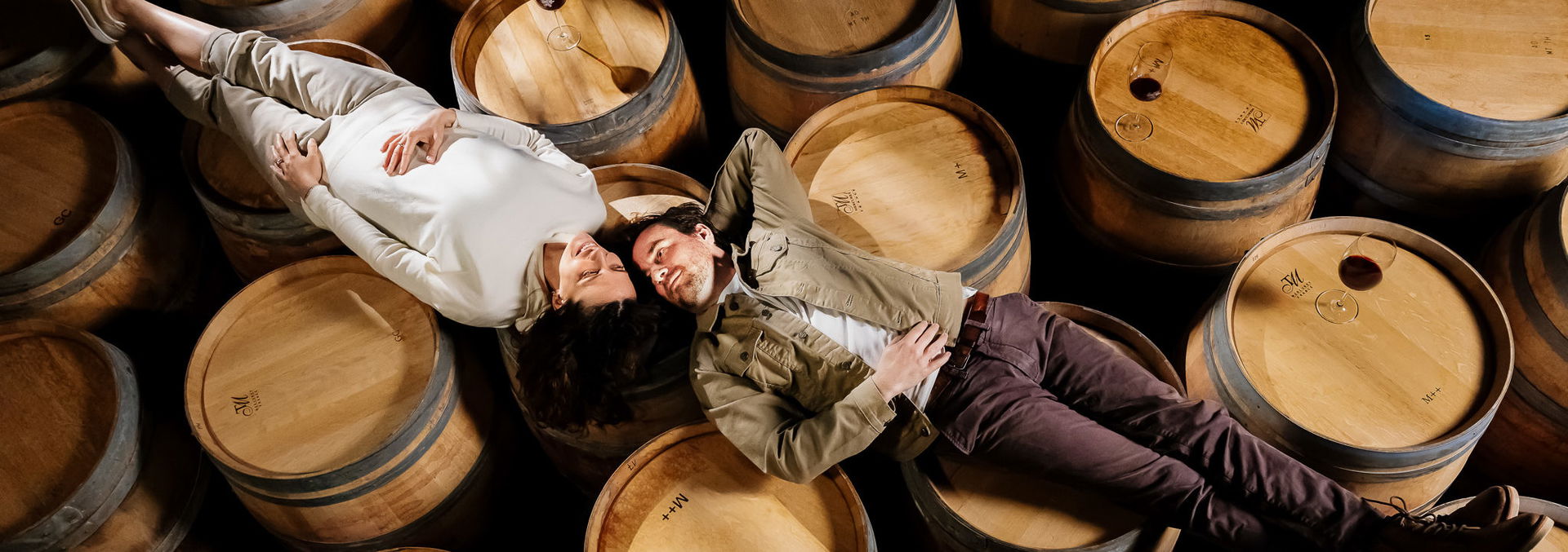 Katja and Patrick from Zeronimo lying on the barrels